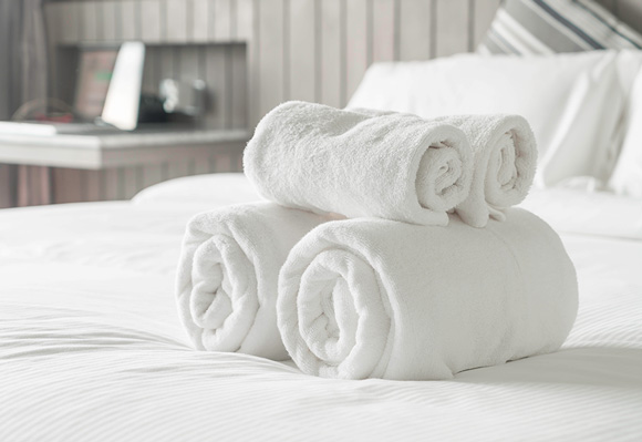 Полотенца на кровати в номере отеля
